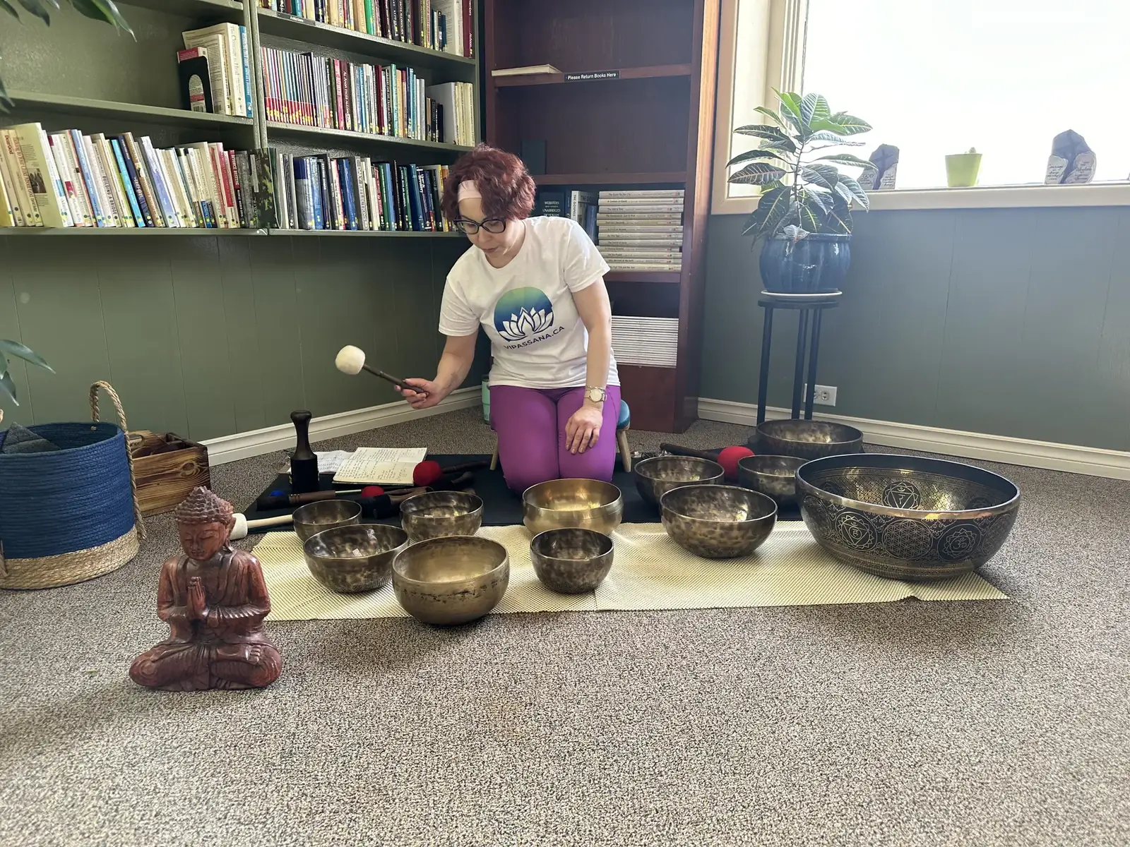 Artem setting up the singing bowls for the sound bath